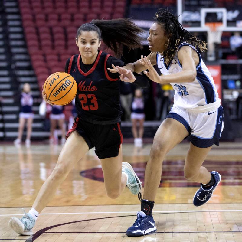 Coronado’s Gabrielle De La Cruz (23) drives toward the hoop while Centennial’s Ci ...