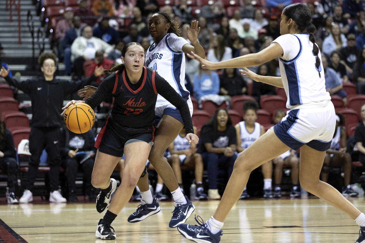 Coronado’s AJ Wick (22) drives toward the hoop between Centennial’s Kaliyah Dilla ...