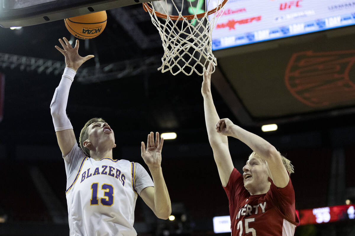 Durango’s Colton Knoll (13) shoots against Liberty’s Tyler Bright (25) during the ...