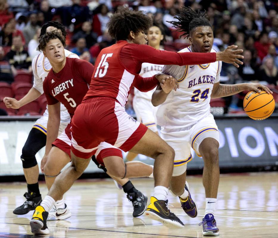 Durango’s Taj Degourville (24) drives past Liberty’s Carlos Bradley (15) during t ...