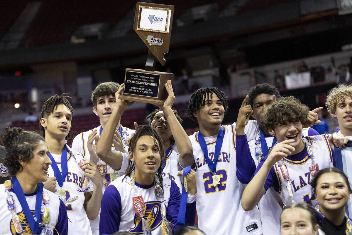 Durango poses for photos with their NIAA Class 5A boys high school basketball state championshi ...