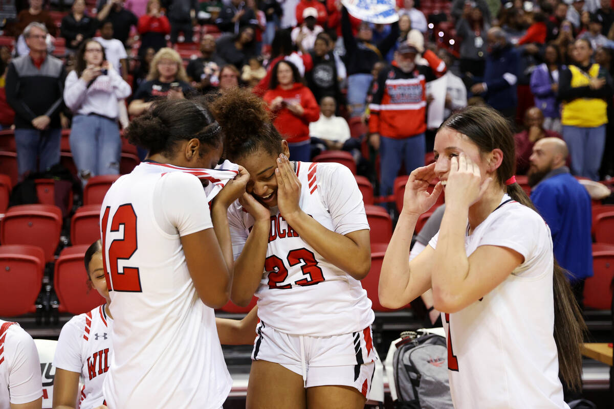 Las Vegas' Jaidyn Savoy (12), Layla Faught (1) and Kayla Terry (23). celebrate after defeating ...