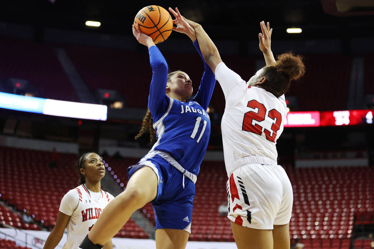 Desert Pines' Alanna Jackson (11) shoots the ball under pressure from Las Vegas' Kayla Terry ( ...