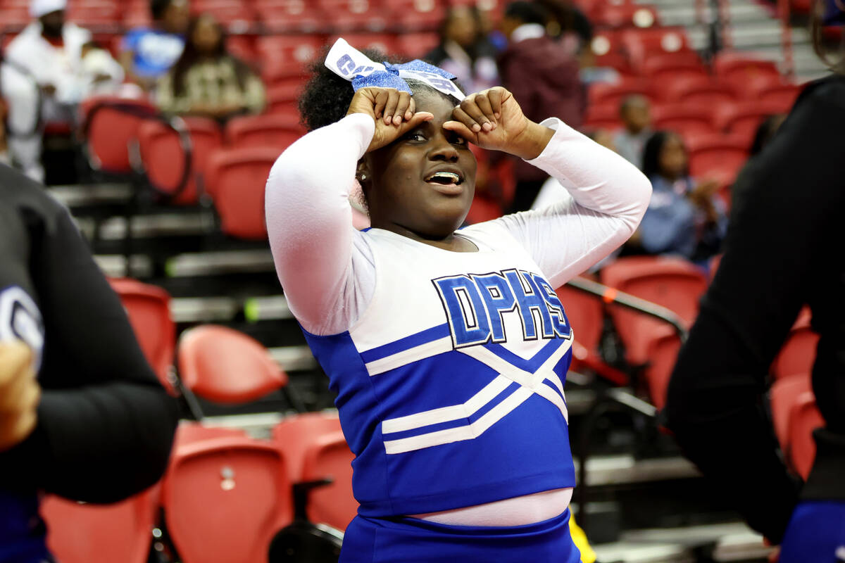 A cheerleader reacts during the class 4A girls high school basketball state championship game b ...