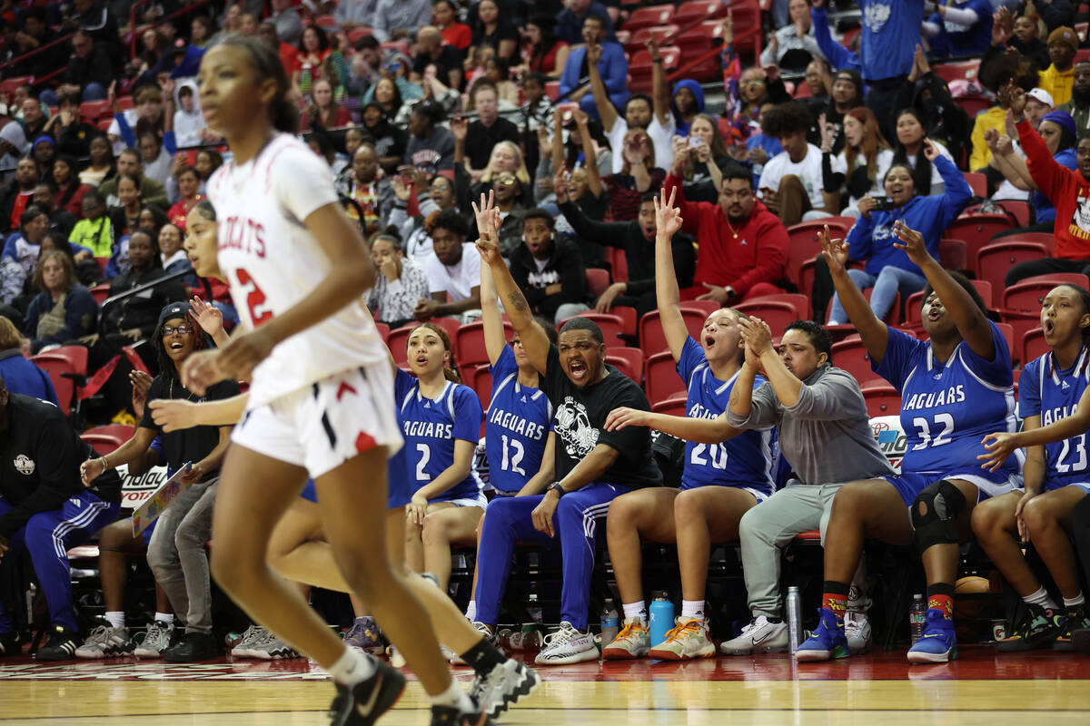 The Desert Pines bench reacts after a score during the class 4A girls high school basketball st ...