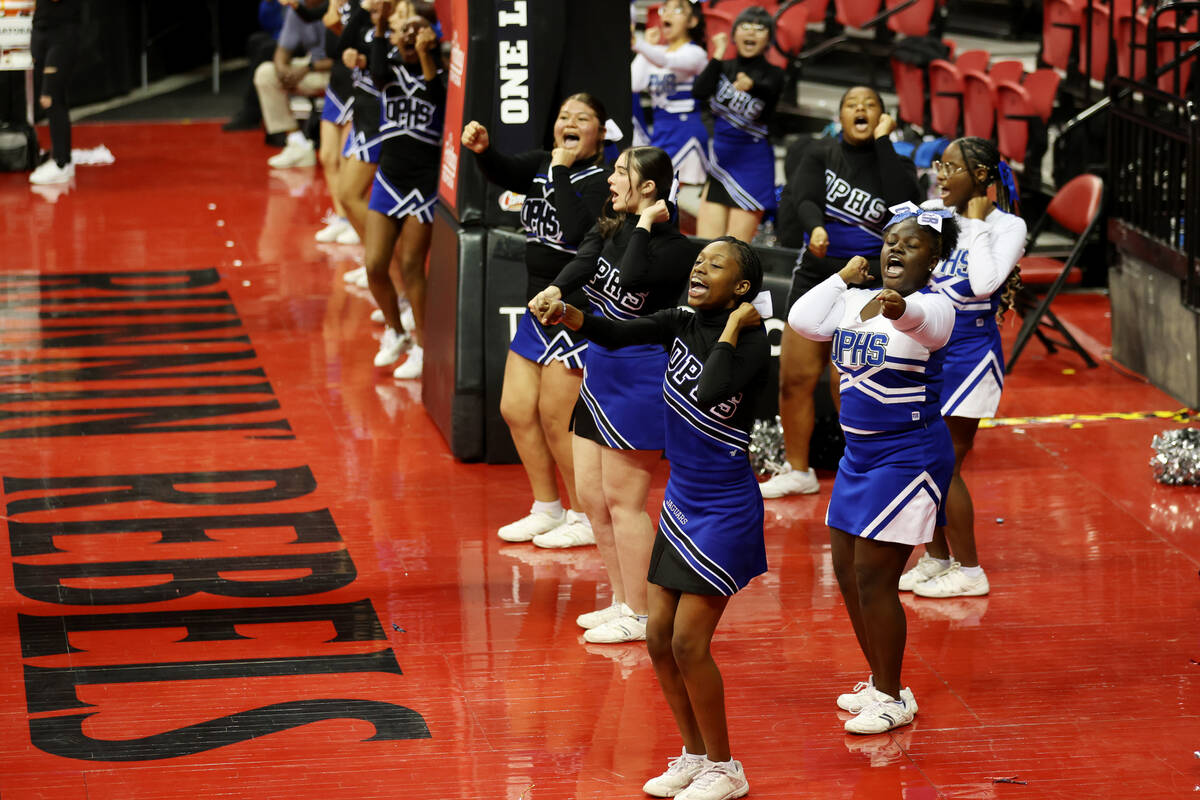 Cheerleader perform during the class 4A girls high school basketball state championship game be ...