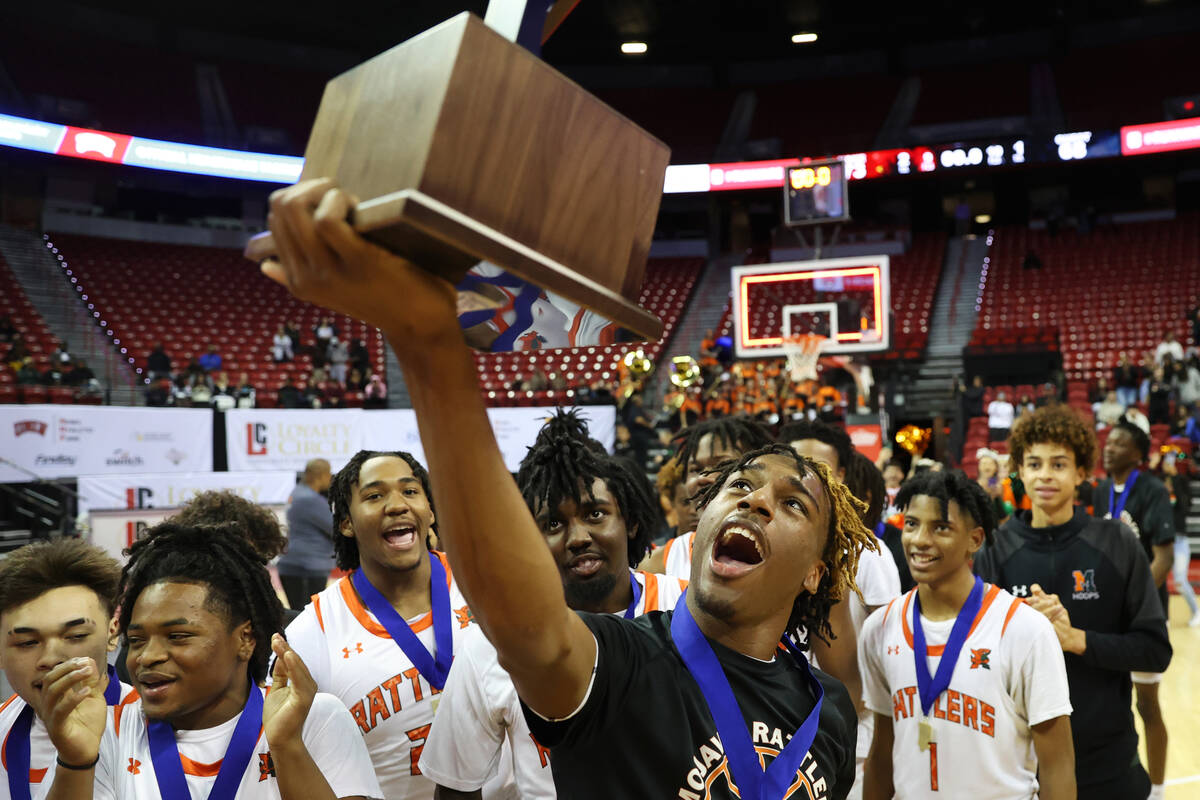 Mojave's Jameer McNeal (5) holds up the championship trophy after defeating Silverado during th ...