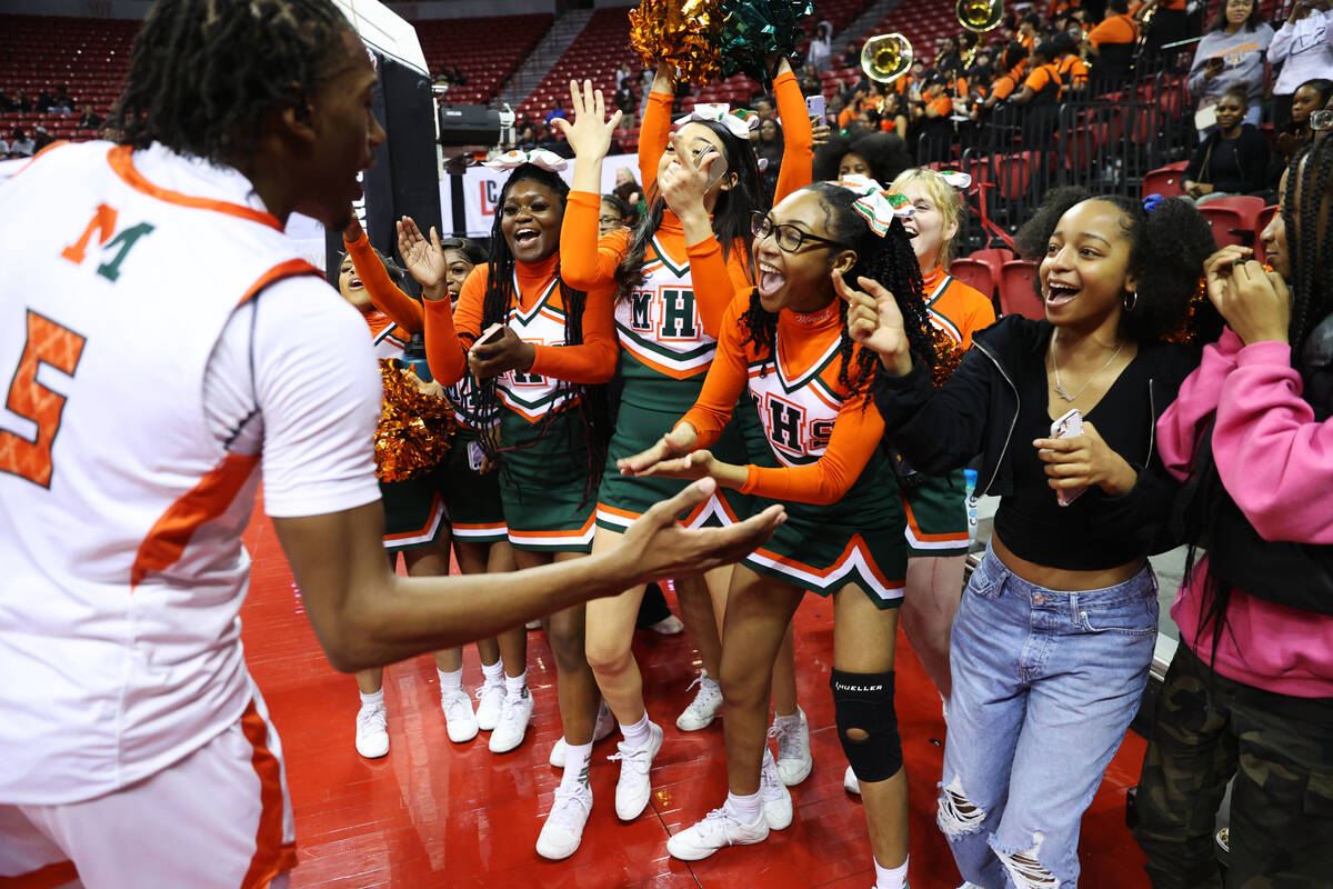 Mojave's Jameer McNeal (5) celebrates after his team defeated Silverado in the class 4A boys hi ...