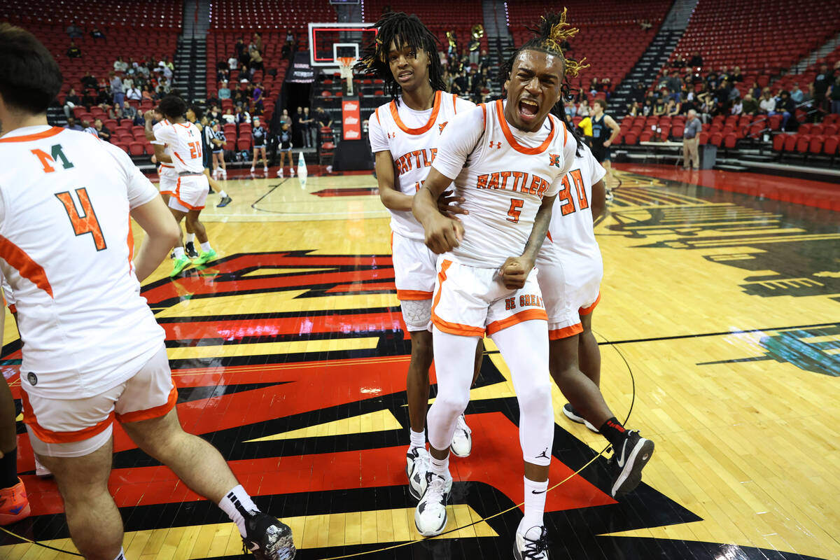 Mojave's Jameer McNeal (5) celebrates with his team after defeating Silverado during the class ...