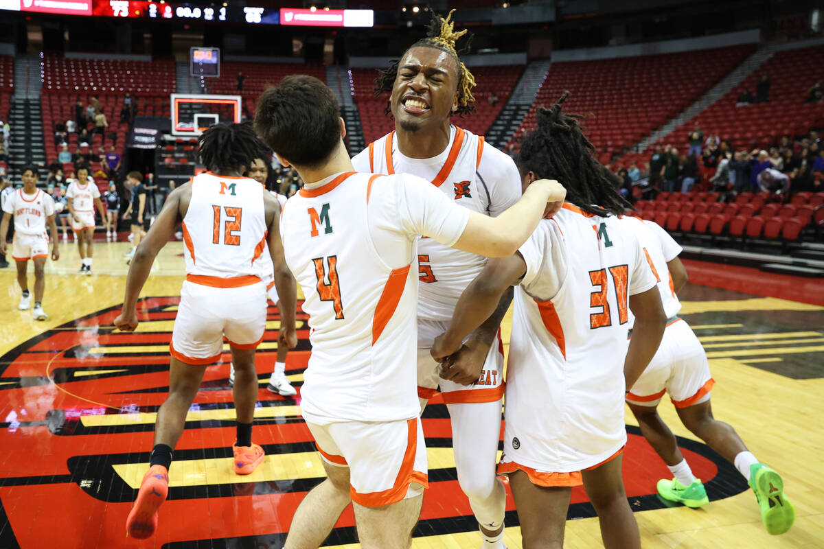Mojave's Jameer McNeal (5) celebrates with Casen Lochridge (4) and Jamoury Porteus-Thomas (30) ...