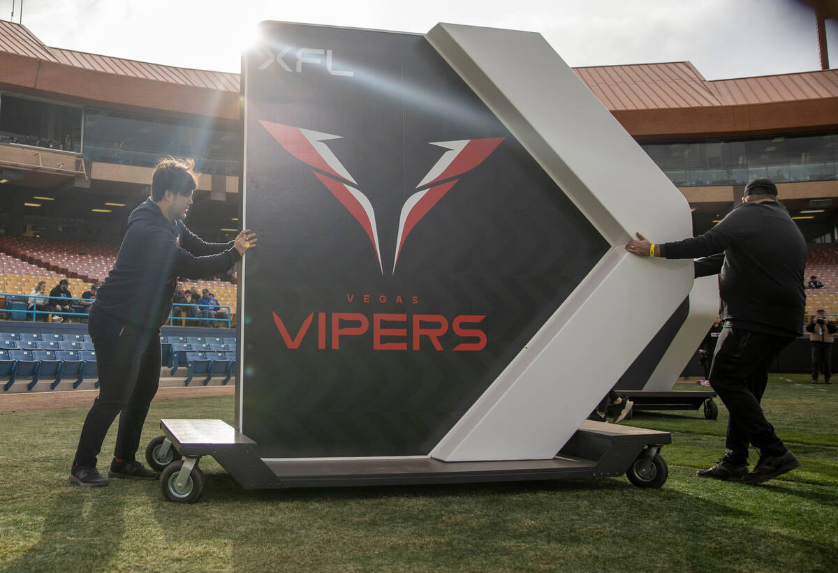 Workers bring out a sign for the Vegas Vipers before an XFL football game at Cashman Field on S ...