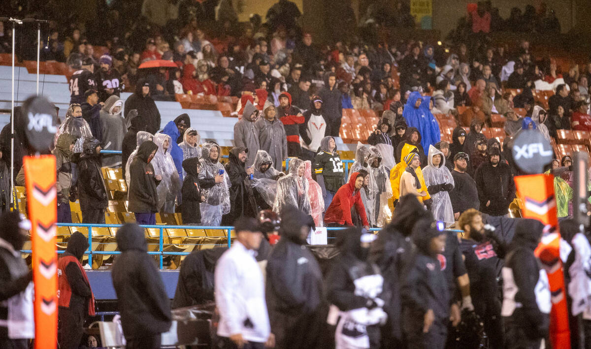 Fans brave the rain during the second half of an XFL football game between the Vegas Vipers and ...