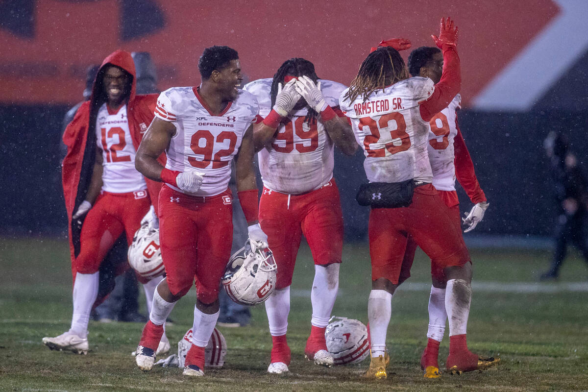 DC Defenders, from left, Jaquez Ezzard (12), Malike Fisher (92), Joe Wallace (99), Ryquell Arms ...