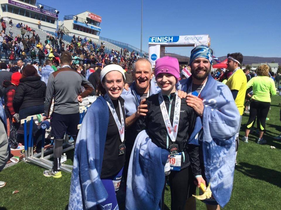 Selena Knowlton (center) stands with her family after competing in a long-distance running even ...