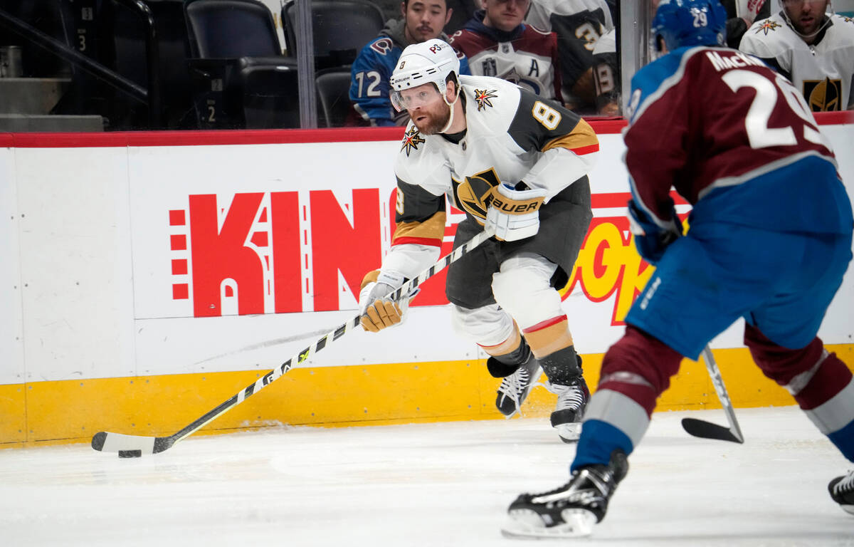 Vegas Golden Knights right wing Phil Kessel, left, shoots as Colorado Avalanche center Nathan M ...