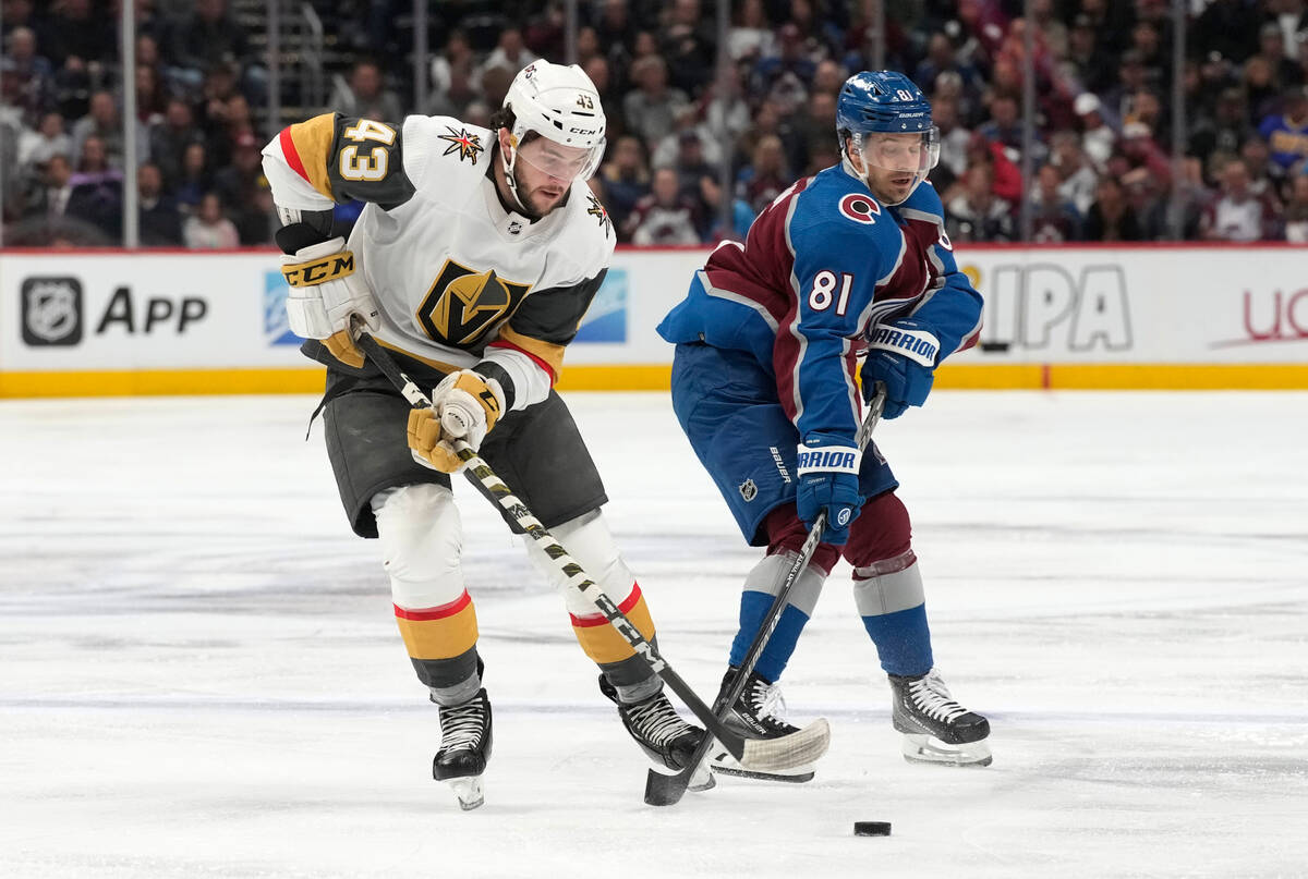 Vegas Golden Knights center Paul Cotter, left, battles for control of the puck with Colorado Av ...