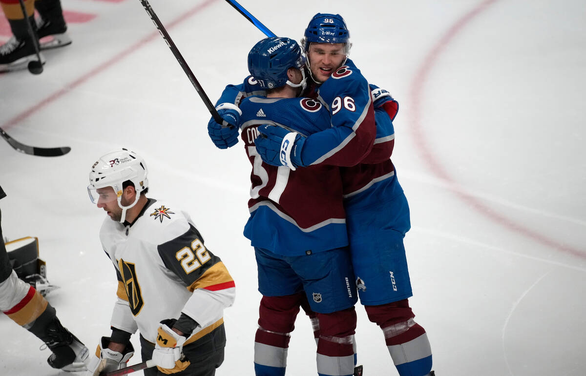 Colorado Avalanche right wing Mikko Rantanen, right, hugs left wing J.T. Compher after scoring ...