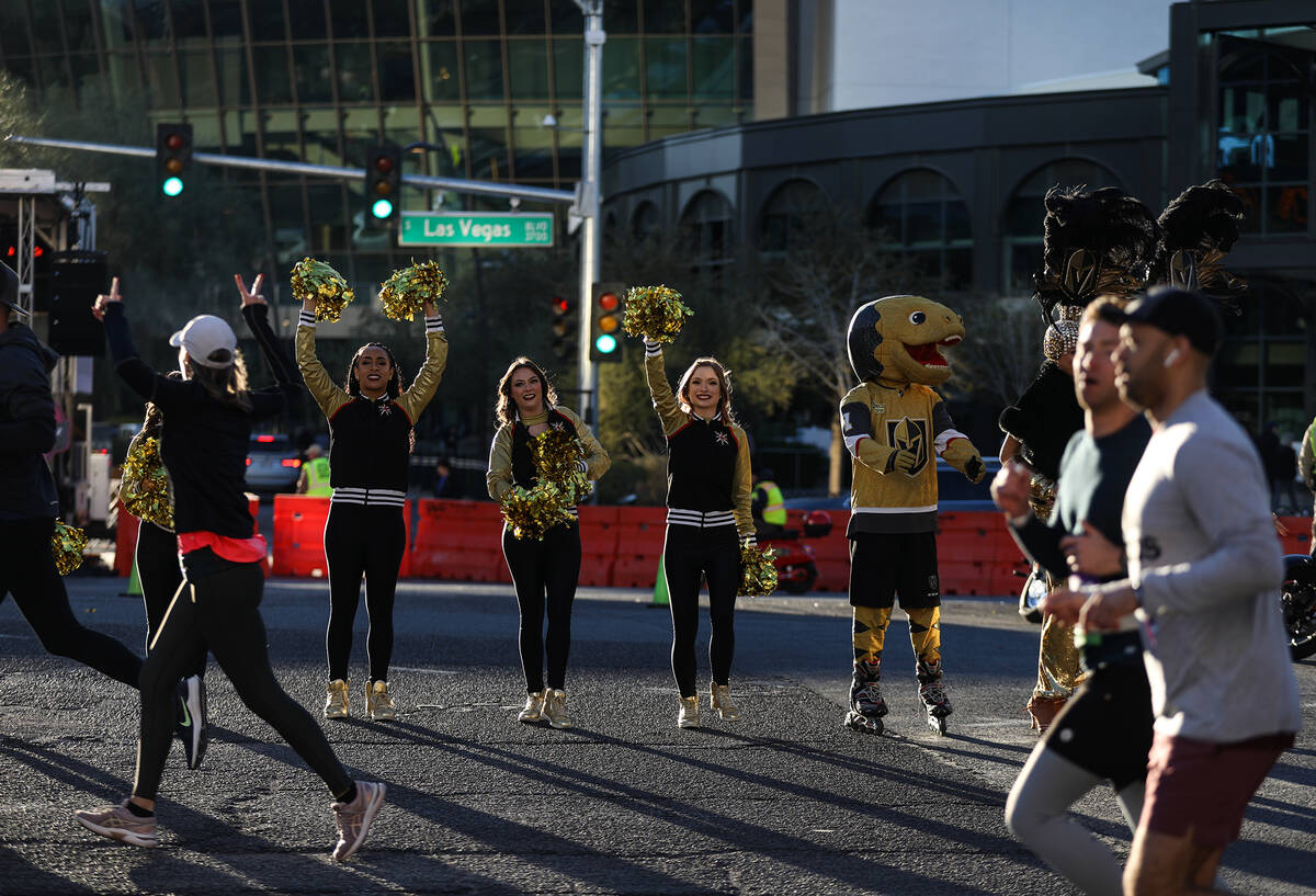 Vegas Golden Knights cheerleader team the Vegas Vivas! and Mascot Chance cheer on runners as th ...