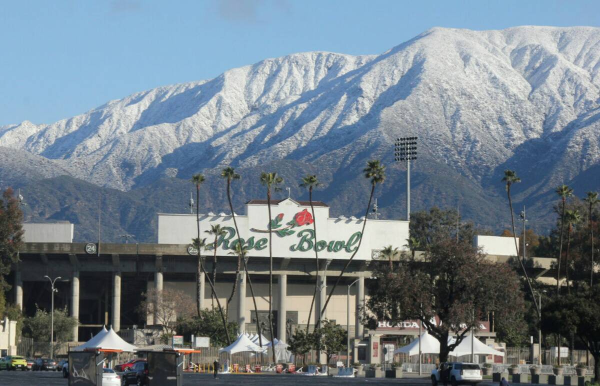 Snow caps the San Gabriel Mountains above the Rose Bowl Stadium in Pasadena, Calif., on Sunday, ...