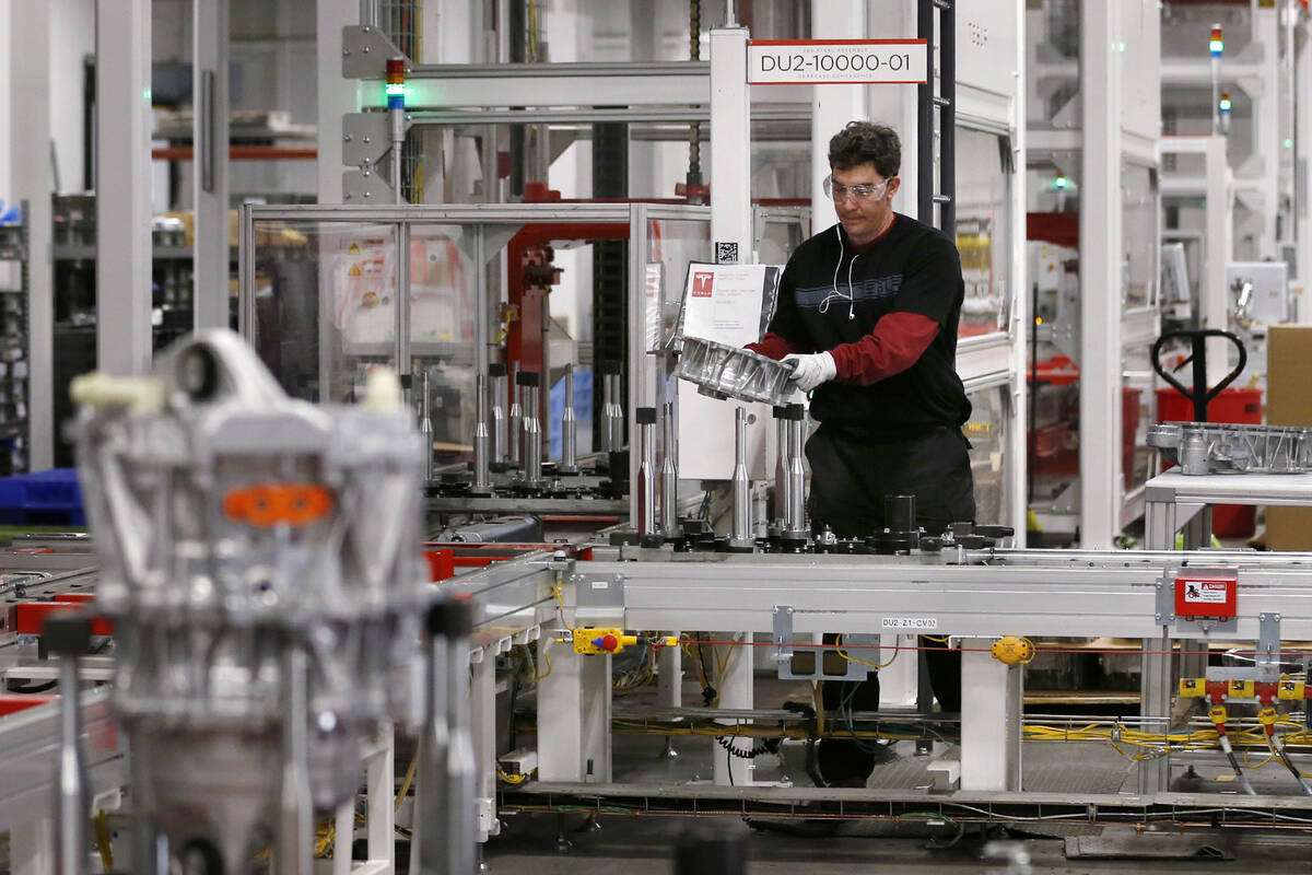 Teakgro Ventra assembles a drive unit at the Tesla Gigafactory, east of Reno, on Tuesday, Dec. ...