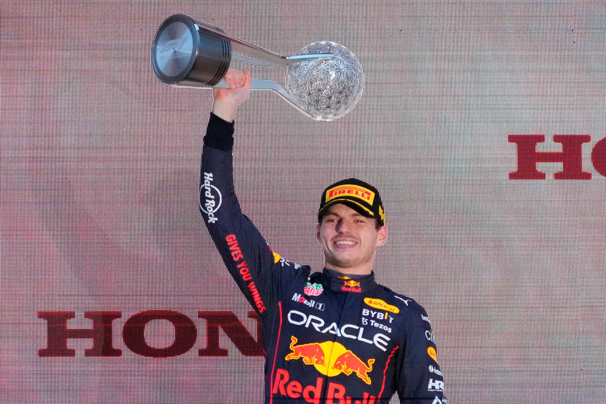 Red Bull driver Max Verstappen of the Netherlands holds aloft trophy on the podium during the J ...
