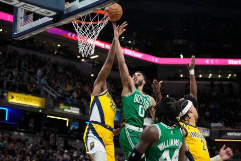 Boston Celtics forward Jayson Tatum (0) shoots against Indiana Pacers center Myles Turner (33) ...