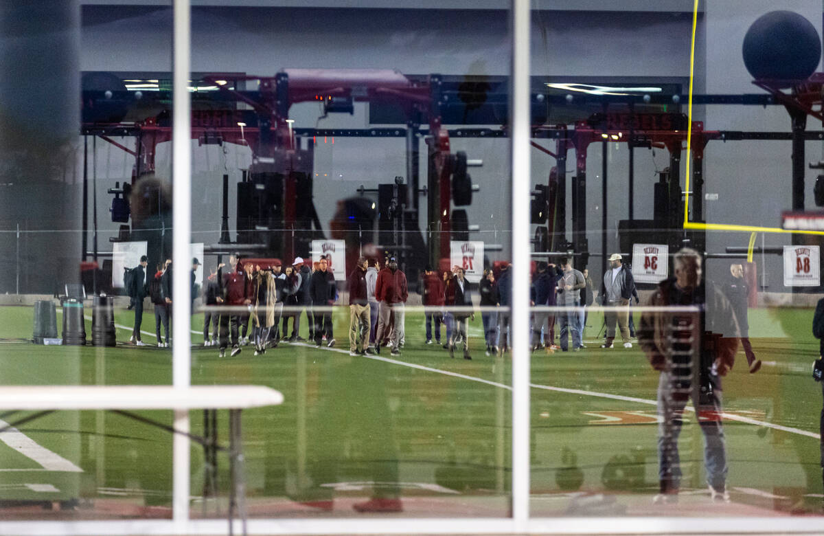 People gather on the 47-yard lines on the field at Rebel Park at the Fertitta Football Complex ...