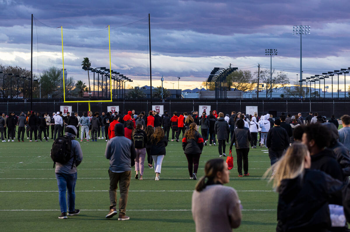 People gather on the 47-yard lines on the field at Rebel Park at the Fertitta Football Complex ...