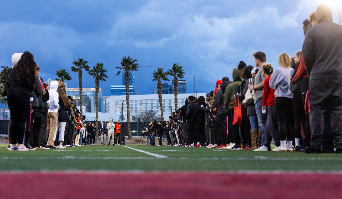 People gather on the 47-yard lines on the field at Rebel Park at the Fertitta Football Complex ...