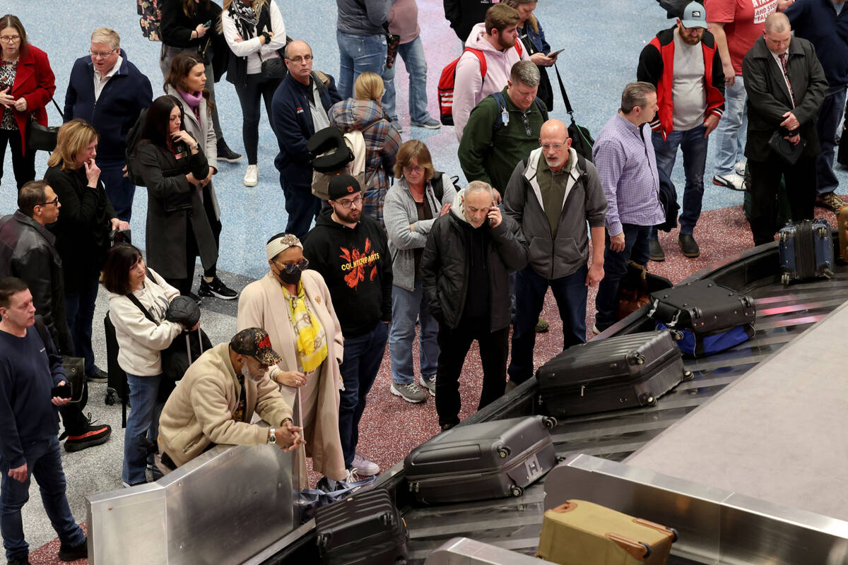 Passengers wait for their luggage in Terminal 1 at Harry Reid International Airport in Las Vega ...