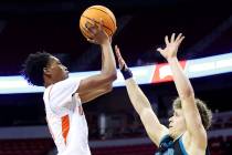 Mojave's C.J. Shaw (3), left, goes up for a shot against Silverado's Jake Wohl (32) during the ...