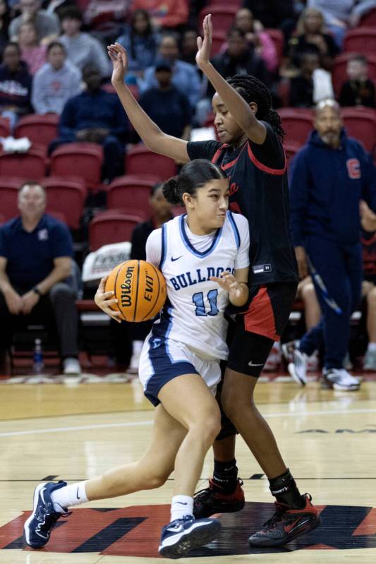 Centennial’s Danae Powell (11) drives toward the hoop past Coronado’s Jaila Child ...