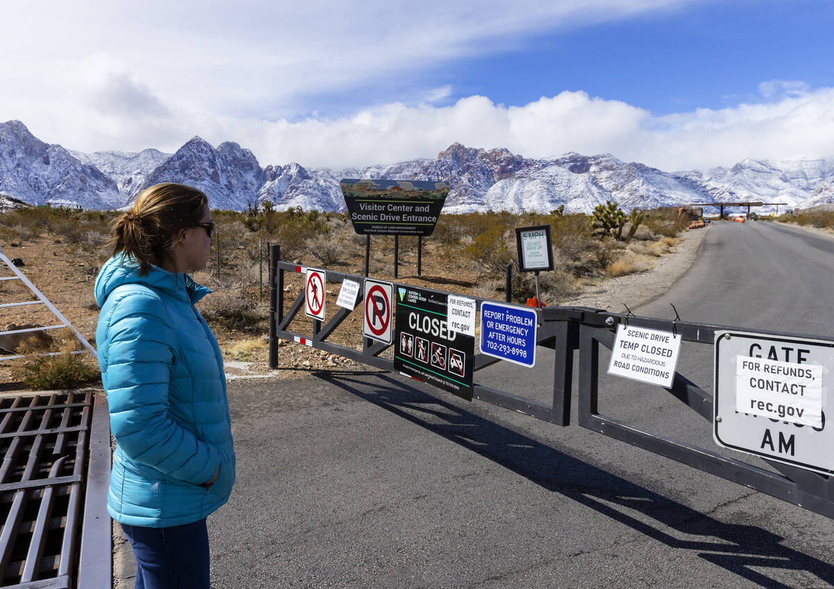 Jessica Melucci, of Boston, stops to read a sign at the entrance of the Scenic Drive, notifying ...