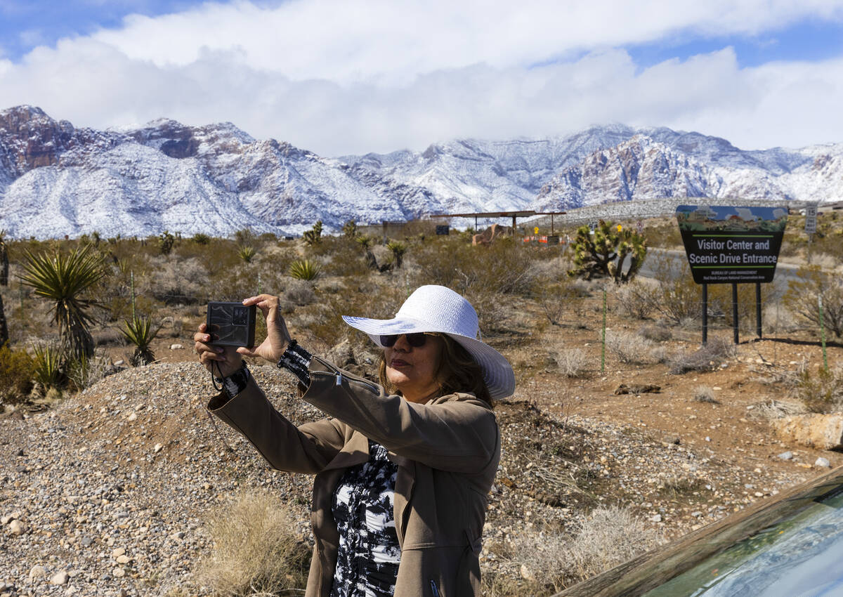 Marilyn Malinay, of Hawaii, takes a selfie at the entrance of the Scenic Drive at the Red Rock ...