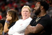 Raiders owner Mark Davis sits with former Raiders fullback Marcel Reece, right, at the Las Veg ...