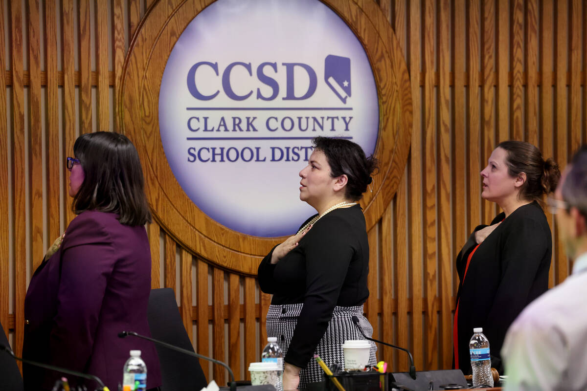 Clark County School Board President Evelyn Garcia Morales, center, recites the Pledge of Allegi ...
