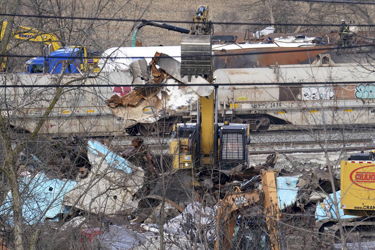 Workers continue to clean up remaining tank cars, Tuesday, Feb. 21, 2023, in East Palestine, Oh ...