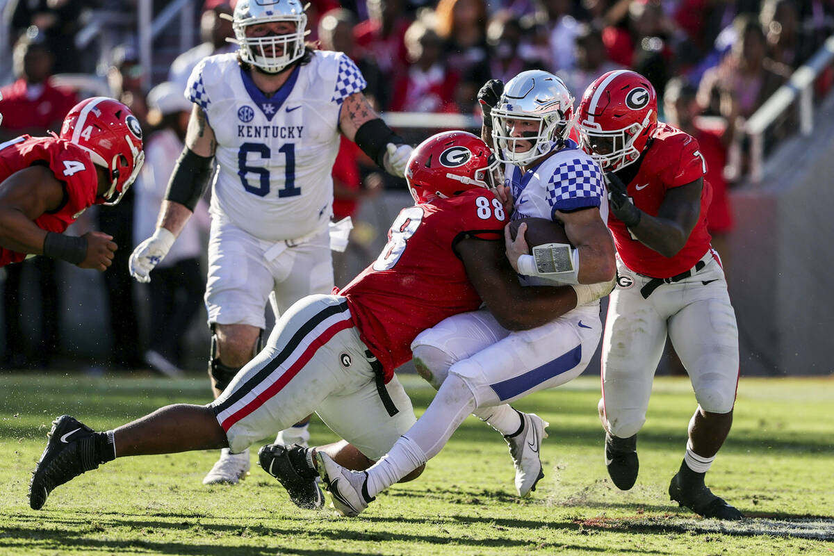 FILE - Kentucky quarterback Will Levis (7) is sacked by Georgia defensive lineman Jalen Carter ...