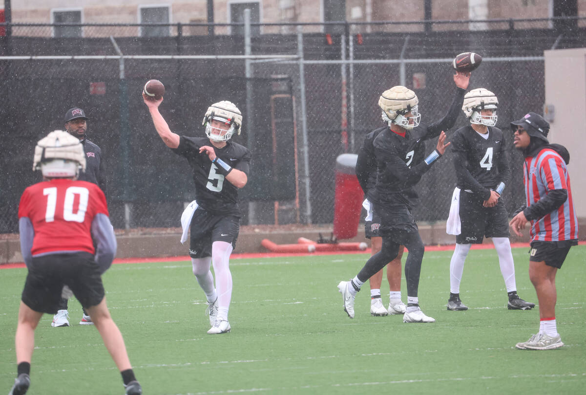 UNLV quarterbacks Harrison Bailey (5) and Doug Brumfield (2) throw passes during the first day ...