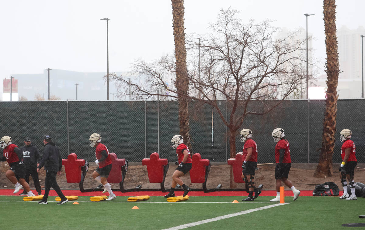 Members of UNLV’s offensive line run through drills during the first day of spring footb ...