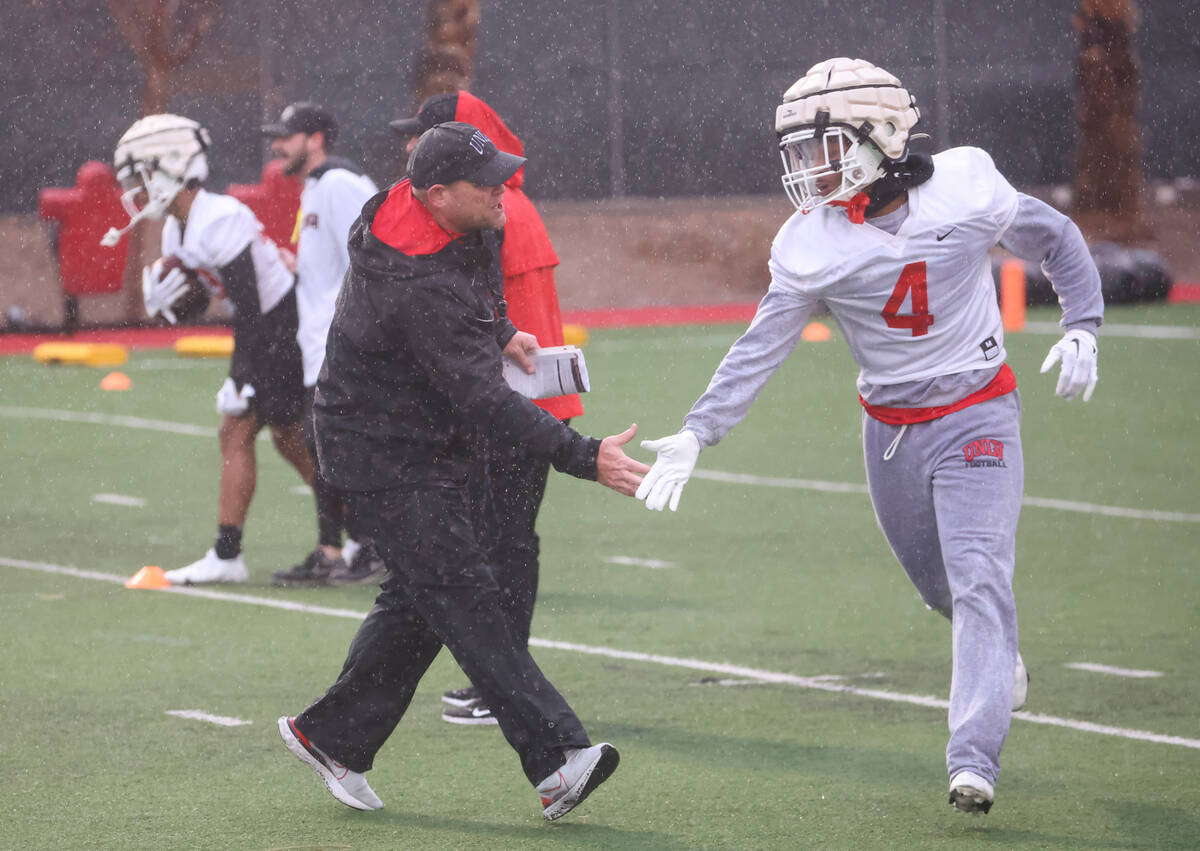 UNLV head coach Barry Odom greets UNLV defensive back Jerrae Williams (4) during the first day ...