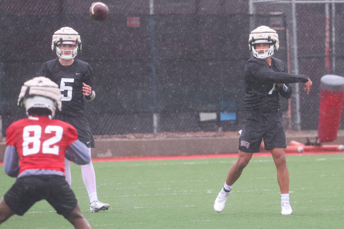 UNLV quarterback Cameron Friel, right, throws a pass during the first day of spring football pr ...