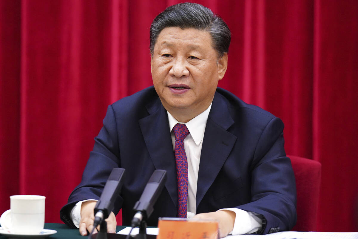 In this photo released by Xinhua News Agency, Chinese President Xi Jinping, speaks at a symposi ...