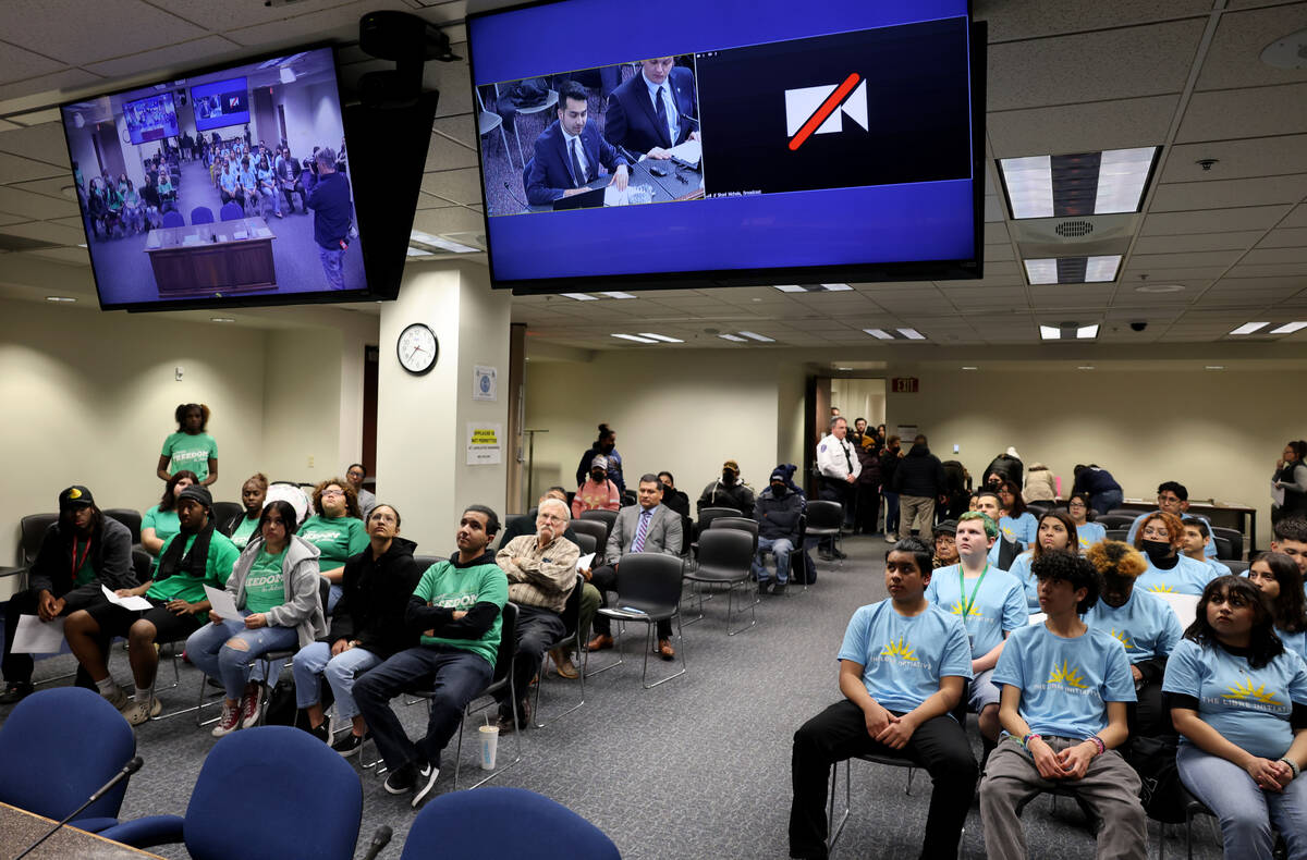 People at the Sawyer Building in Las Vegas watch meeting addressing SB92 via video conference f ...