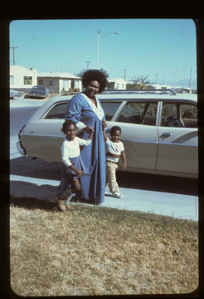 Ruby Duncan holds the hands of two children on a sunny driveway. Courtesy Ruby Duncan.