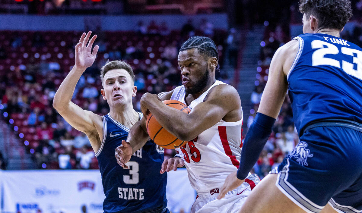 UNLV guard EJ Harkless (55) drives on Utah State guard Steven Ashworth (3) during the first hal ...