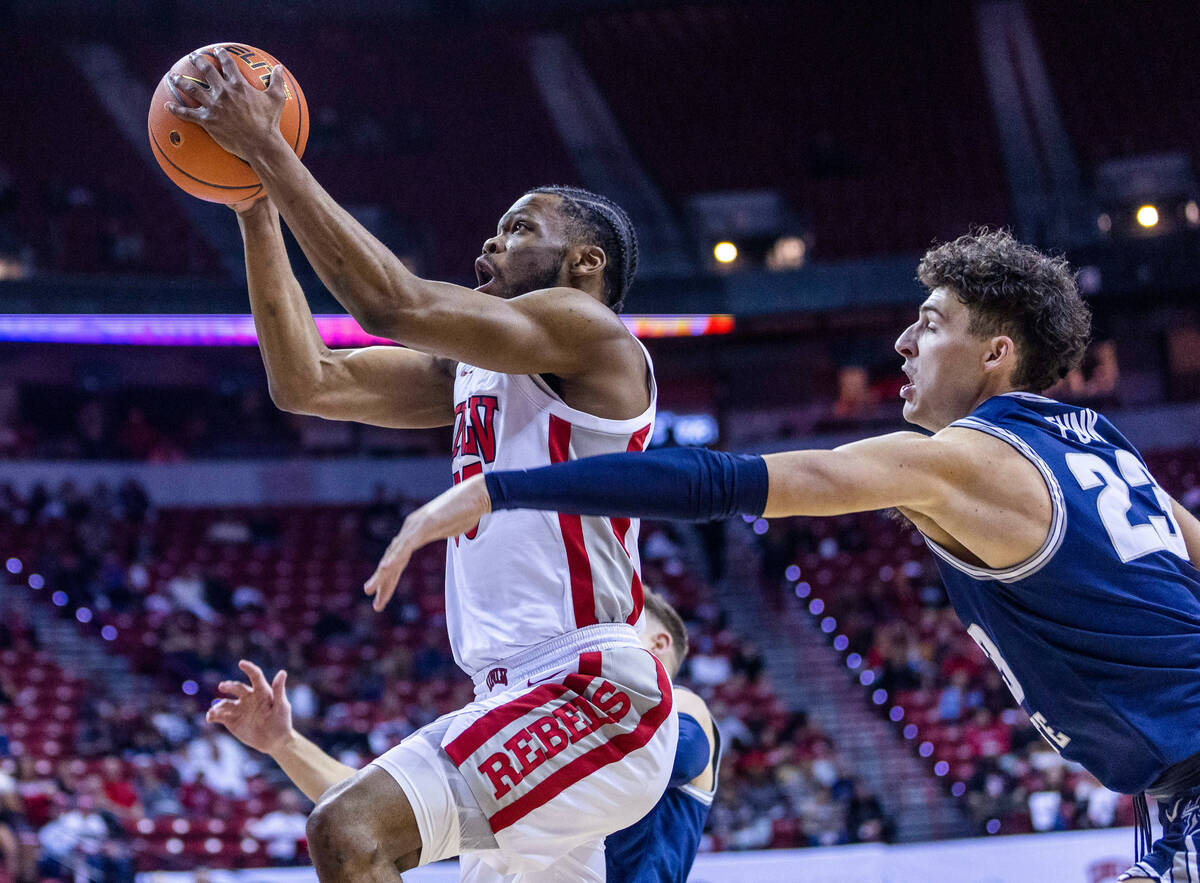 UNLV guard EJ Harkless (55) sets up for a shot past Utah State forward Taylor Funk (23) during ...