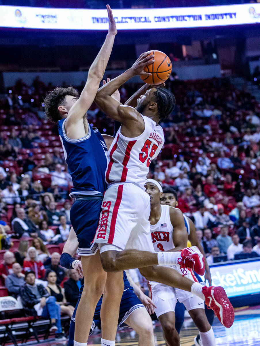 UNLV guard EJ Harkless (55) sets up for a shot overUtah State forward Taylor Funk (23) during t ...