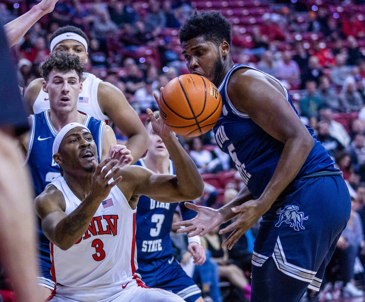 UNLV guard Shane Nowell (3) looks to a loose ball with Utah State guard RJ Eytle-Rock (5) durin ...