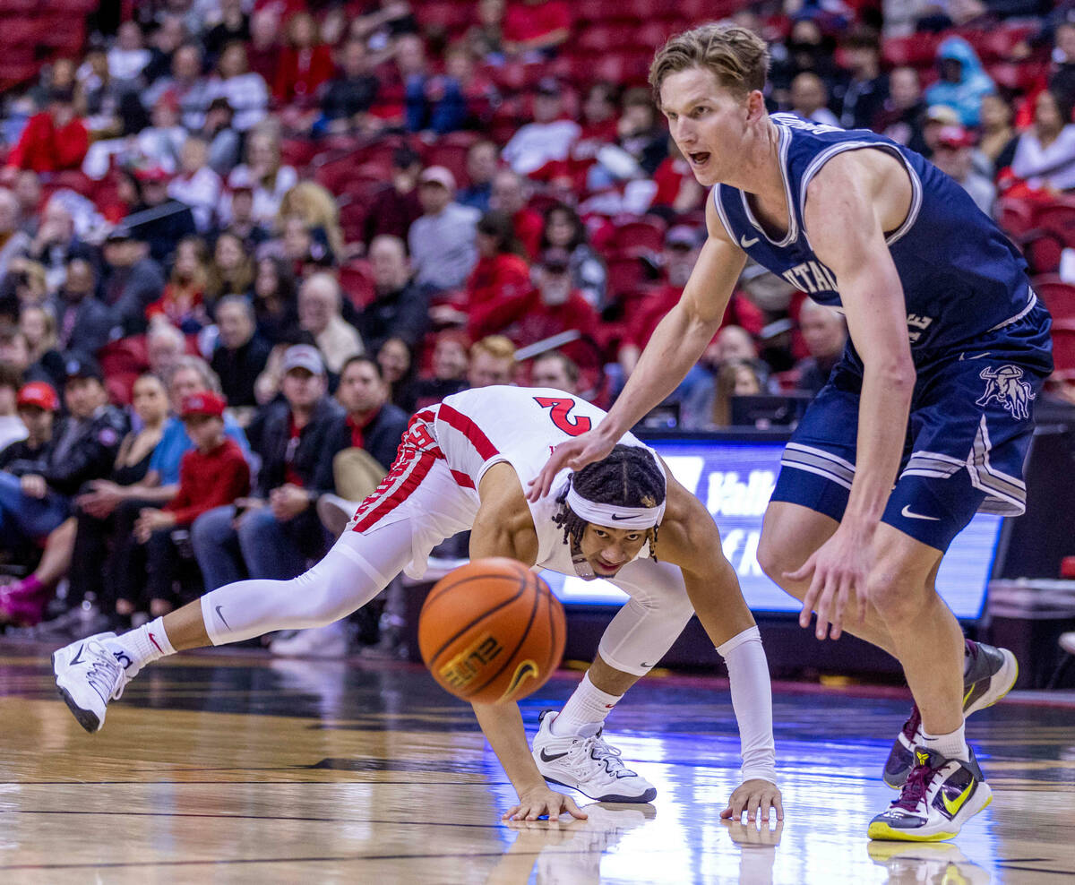 UNLV guard Justin Webster (2) looks to the ball he lost as Utah State guard Sean Bairstow (2) e ...